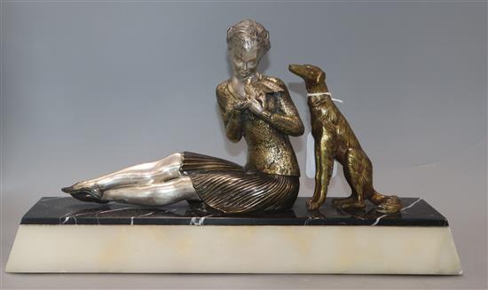 A Salvado Art Deco model of a girl with a bird and a dog length 42.5cm